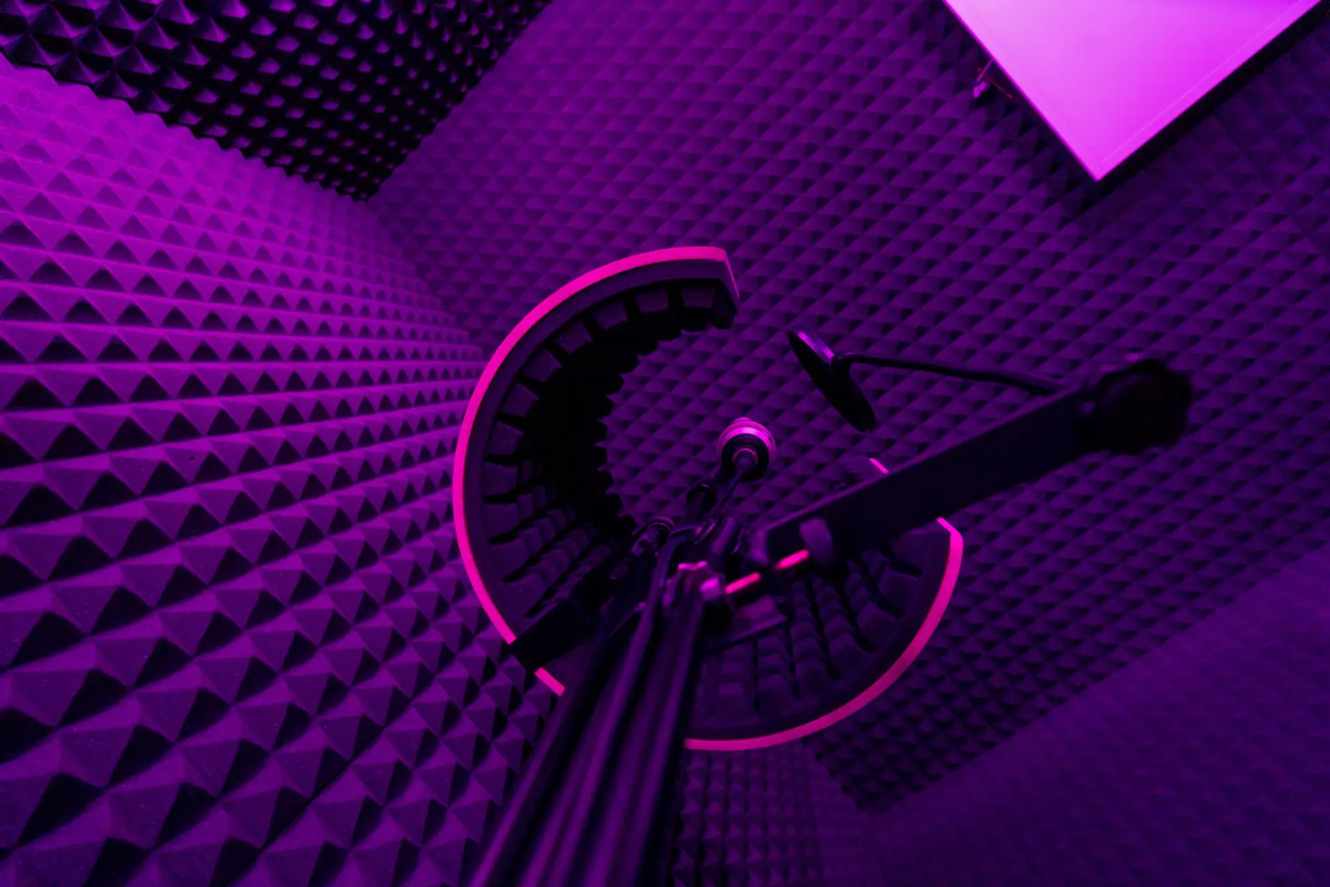 professional recording studio song recording equipment microphone closeup bottom view purple neon light